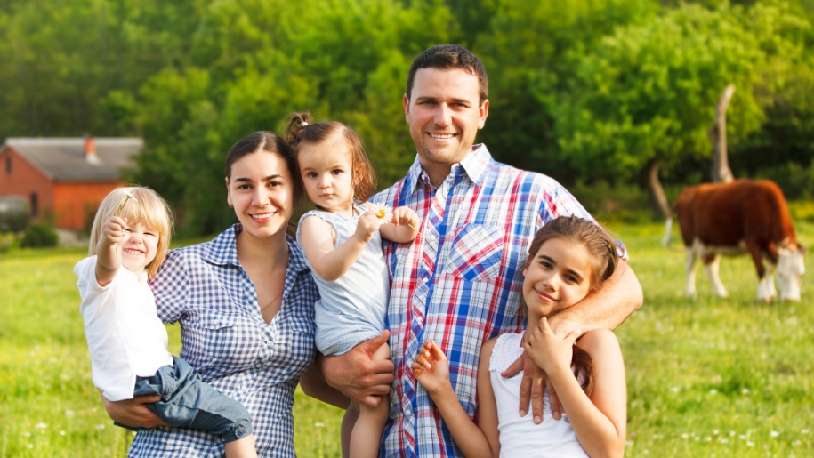 family in field with cows