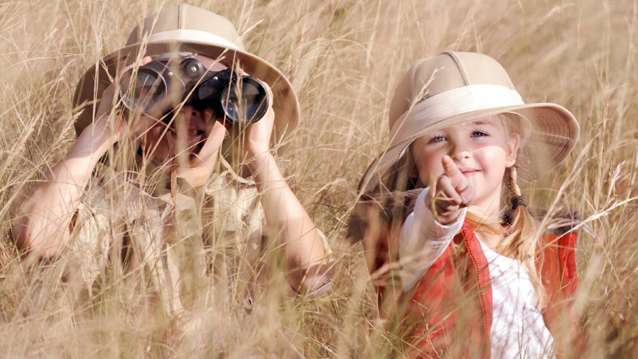 kids dressed in safari clothes hiding
