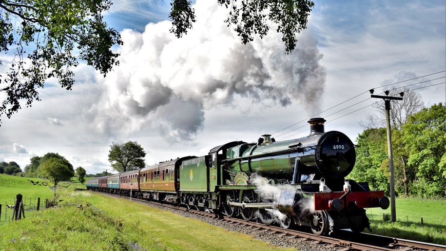 steam train going through countryside