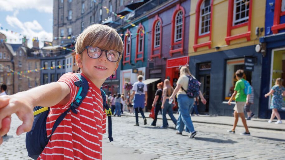 boy with red shirt leads parent around town