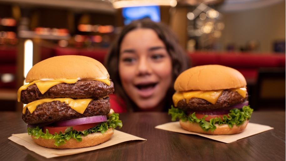 girl looking at two burgers at Hard Rock Cafe