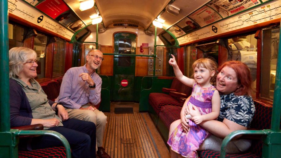 Family in a vintage tube carriage at London Transport Museum