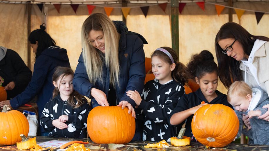 Family carving pumpkins at Tumblestone Hollow