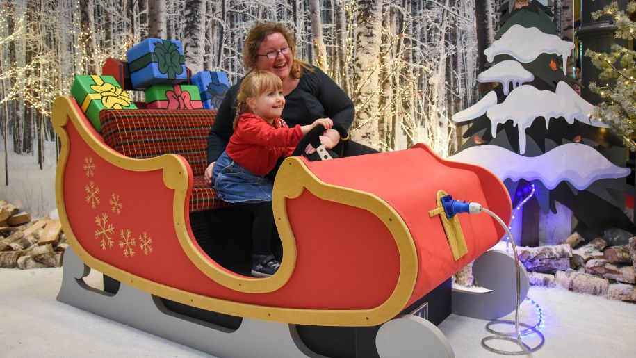 Families in a Chirstmas sleigh at london transport museum
