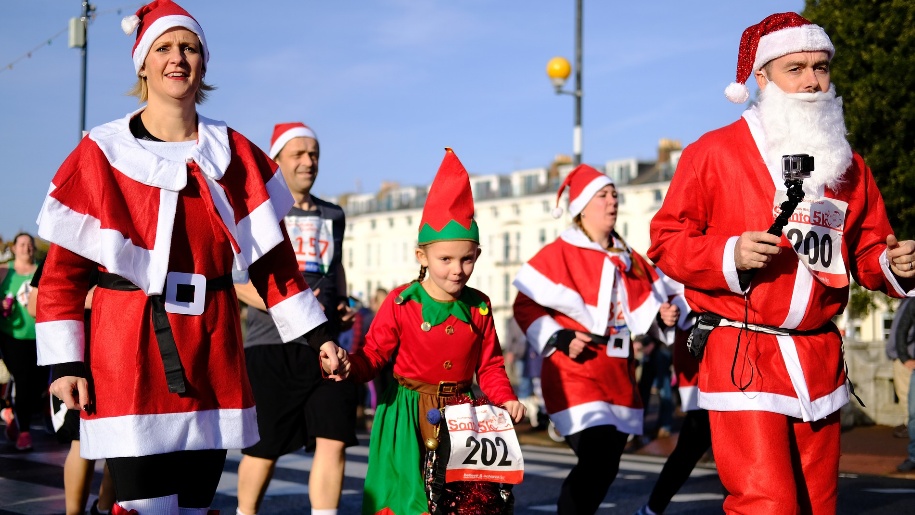 people dressed up as santa on run