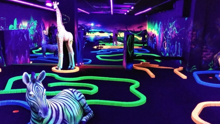 Models of animals on an indoor Glow Golf course.
