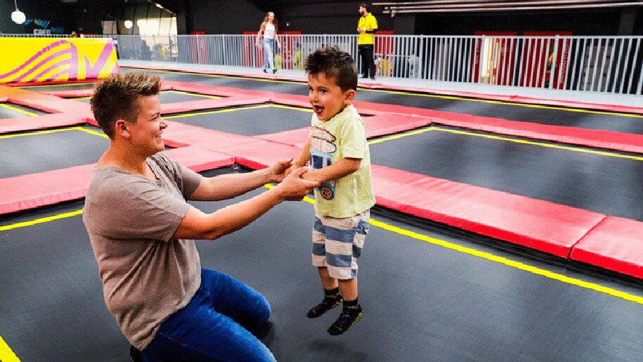 adult helping young child to bounce at a RedKangaroo Trampoline Park