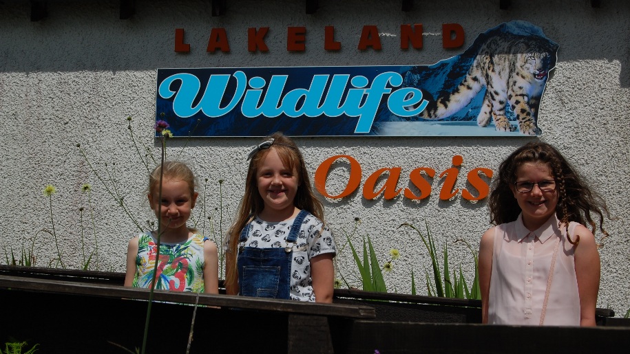 kids in front of wildlife sign