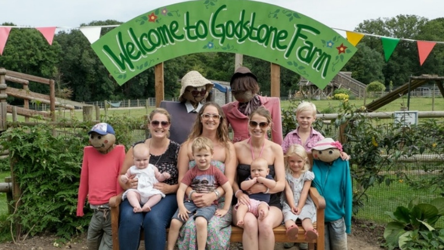 family sitting together at Godstone Farm