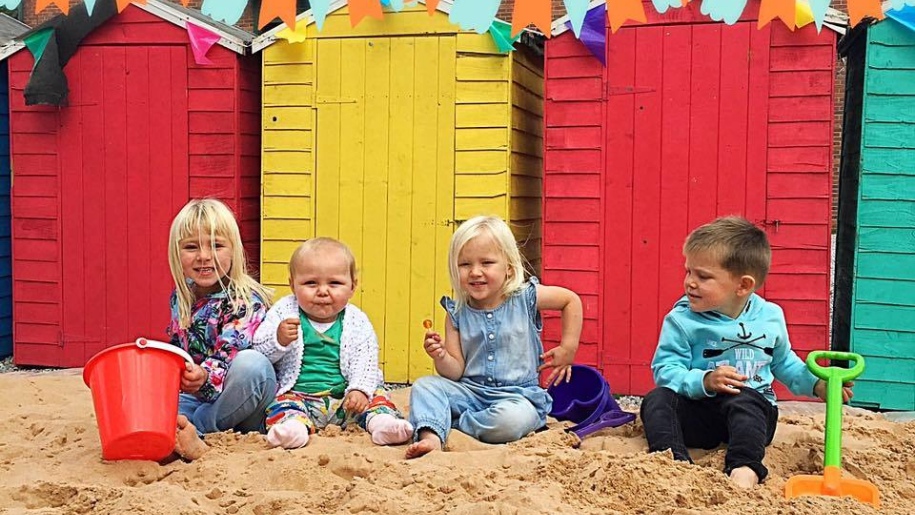 kids on a beach with beach huts at National Coal Mining Museum