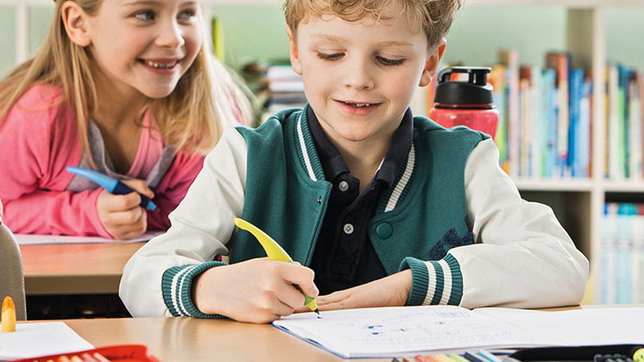 boy writing with stabilo pen