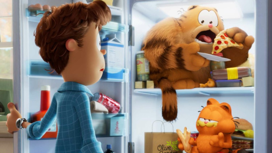 John looks at two cats, one the titular Garfield, eating food in an open fridge.