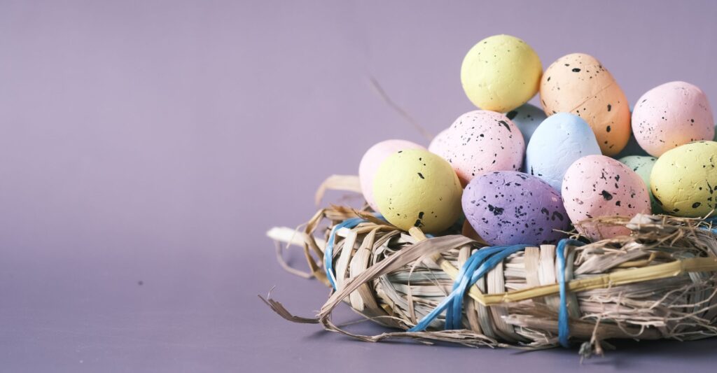 Basket of Easter eggs in pastel colours.