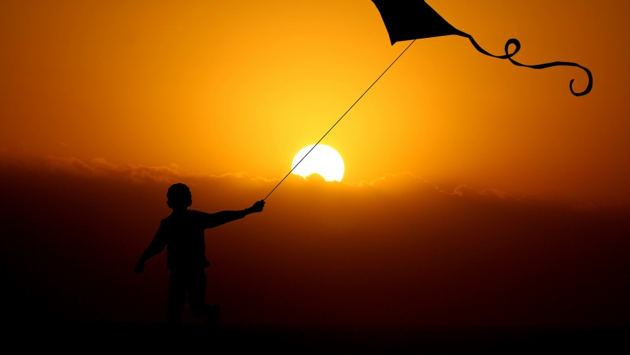 child flying a kite