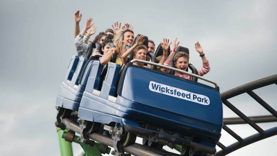 wicksteed park ride with people with hands in air