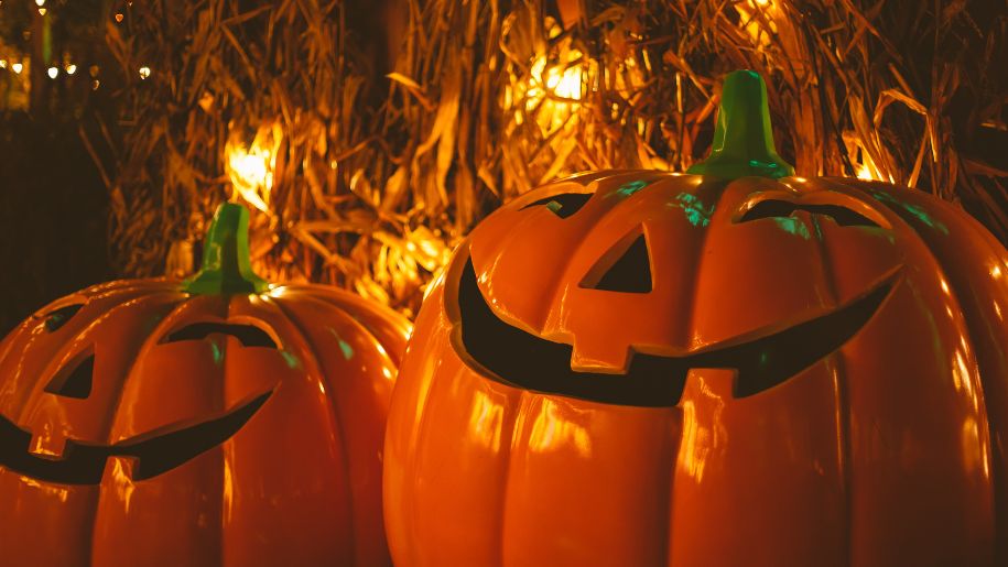 Two pumpkins with friendly spooky faces on