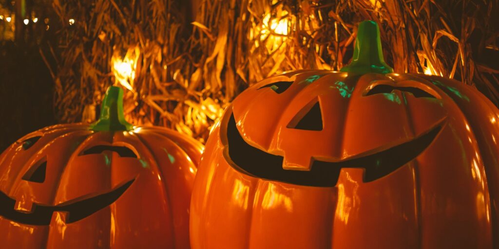 Two pumpkins with friendly spooky faces on