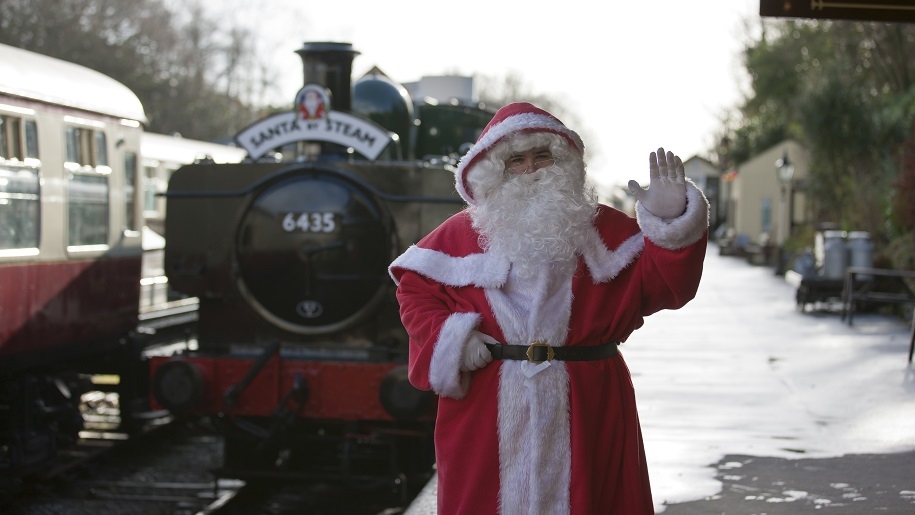 Santa waving by a train at the Bodmin and Wenford Railway in Cornwall.