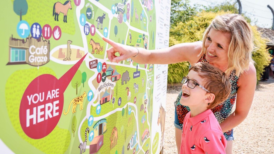 mum and boy looking at map of Marwell Zoo