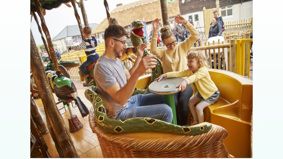 family of 3 in a snake basket carousel ride