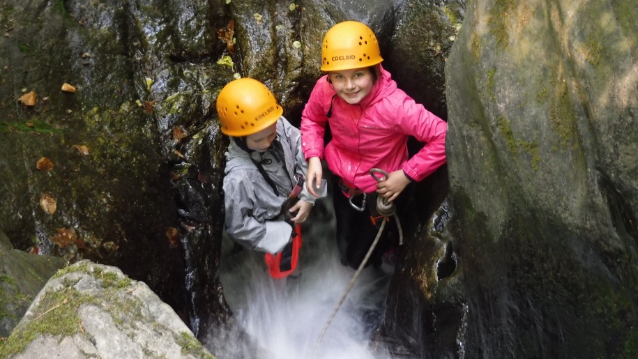 Children joining in an adventure activity.