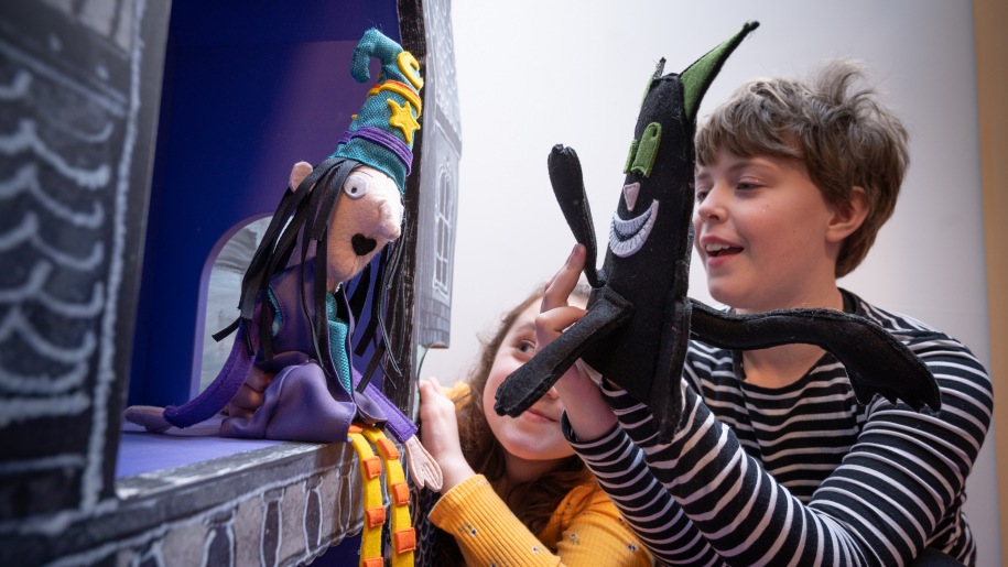 Children playing with puppets at The Story Museum Oxford.