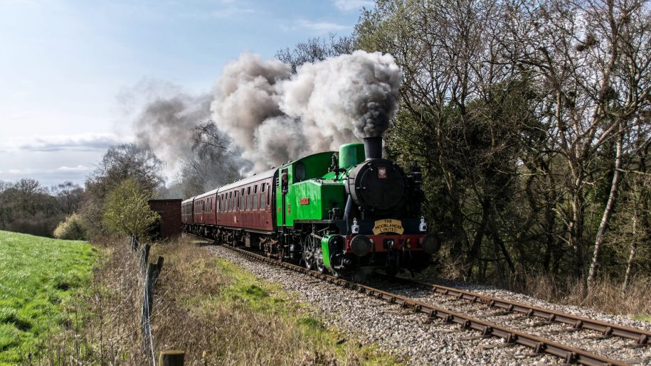 Steam train making a summer trip along the Churnet Valley Railway in Staffordshire.