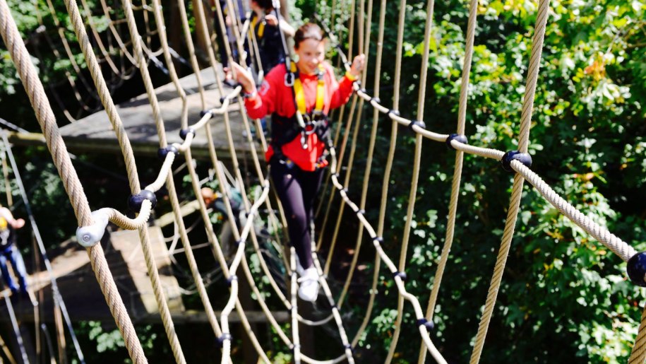 girl crossing high wire bridge at Wildwood