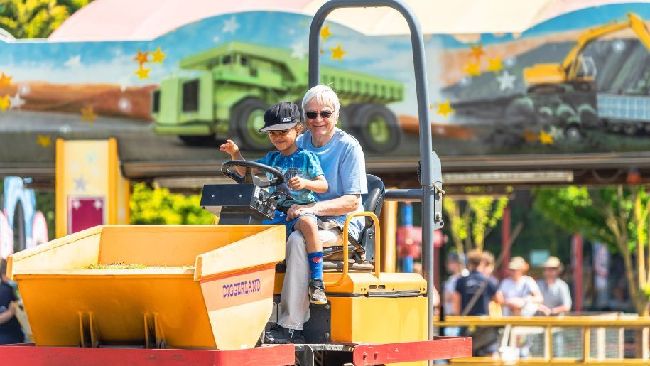 Grand parent and child on a digger ride at Diggerland