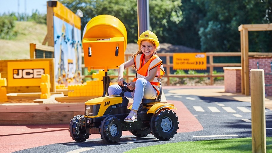 Girl on toy JCB at Adventure Land
