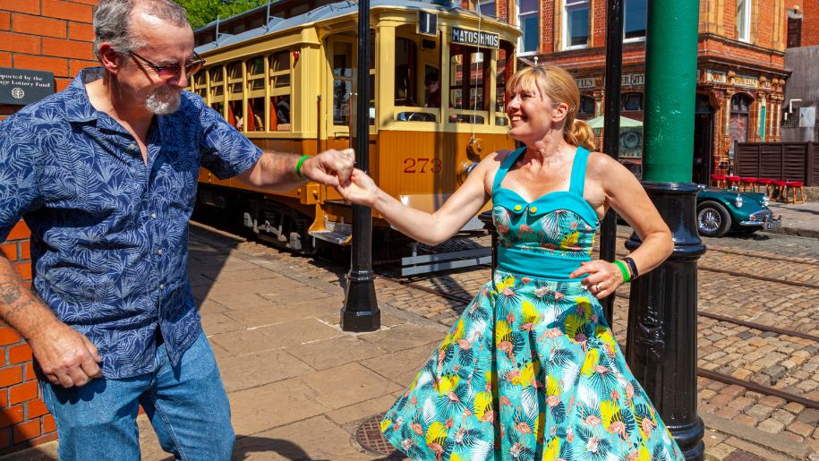 Man and woman swing dancing at Crich Tramway Village