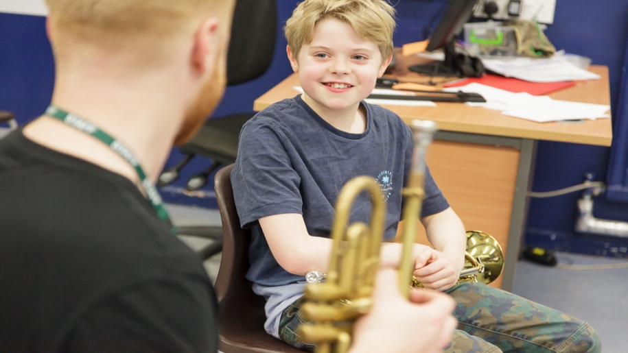 Saffron Centre for Young Musicians - Saffron Walden - Young boy with horn listening to his mentor