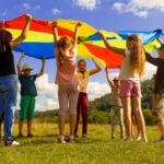 Children playing parachute in a field