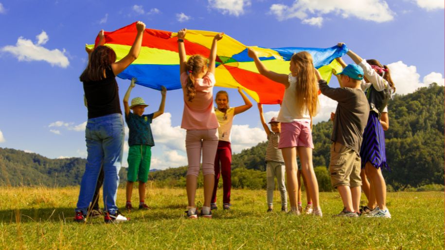 Children playing parachute in a field