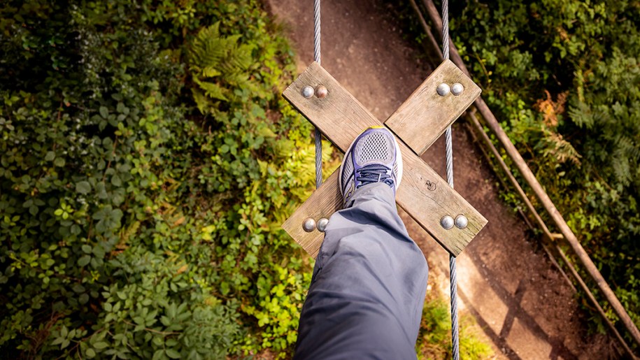 View of visitor's foot on high-level crossing at Go Ape