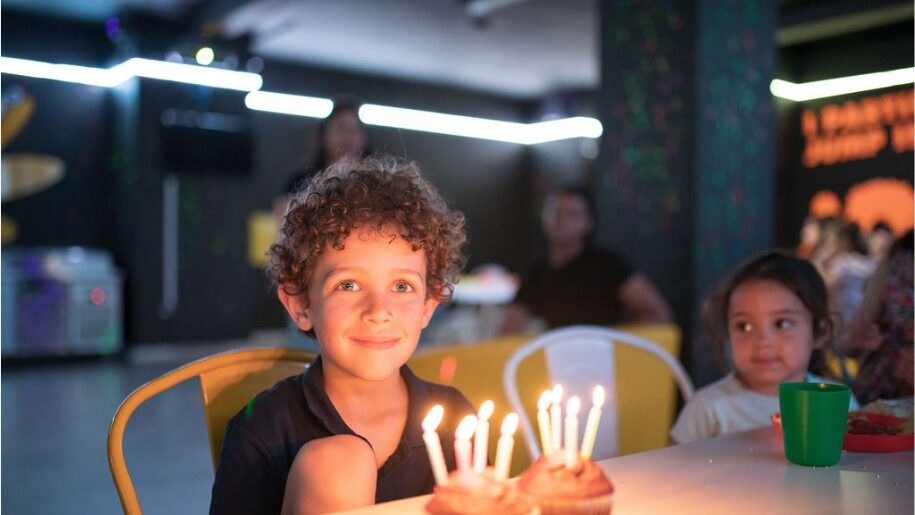 Jump In Esher - boy sitting in front of birthday cake