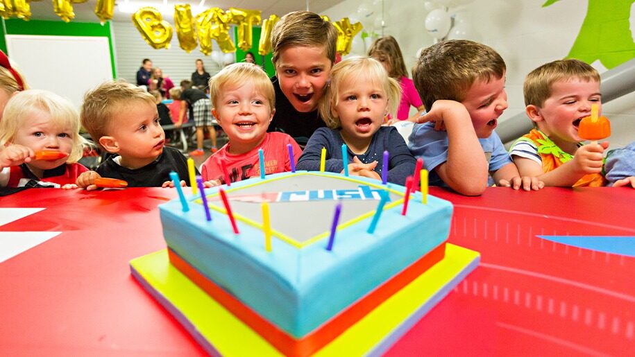 Young children with birthday cake at Rush