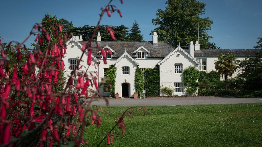 Sir Harold Hillier Gardens - Front of house with red flowers in the foreground