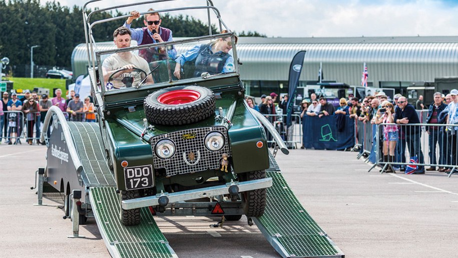 Land Rover negotiating obstacle in arena