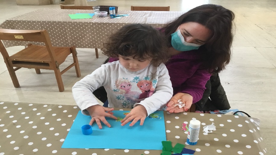 Guildford Cathedral - Cathedral Tots - Mother with child on her lap working with paper.