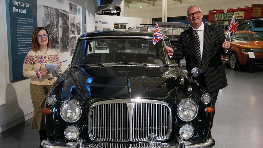 museum staff with black vintage car and small Union Jack