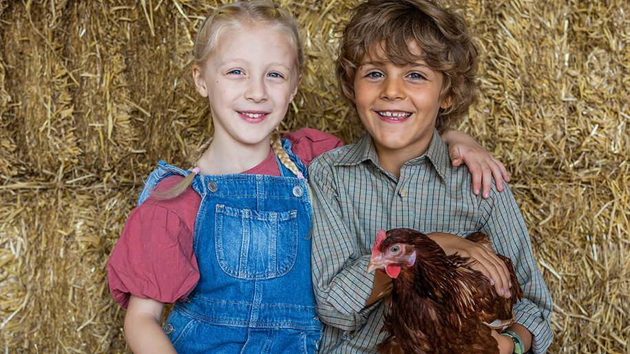Longdown Activity Farm - girl and boy holding a chicken
