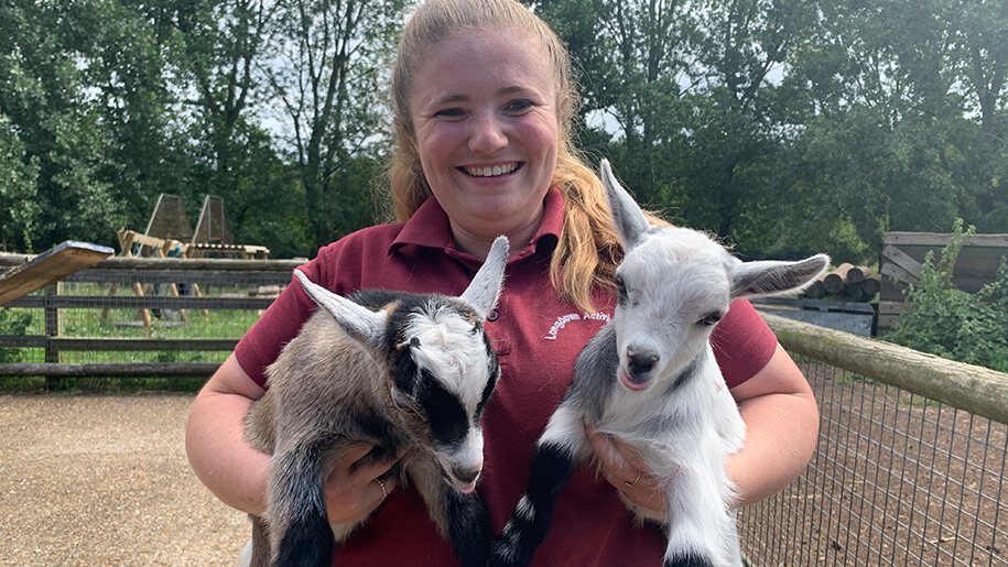 Longdown Activity Farm - Girl holding young goats