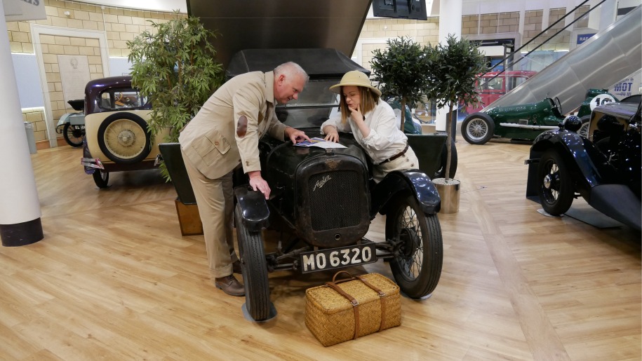 costumed characters looking under bonnet of Austin Seven at British Motor Museum