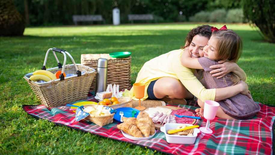 mum and daughter hugging at picnic