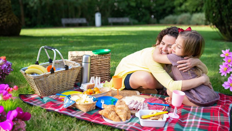 Mother and Daughter having a summer picnic on a field