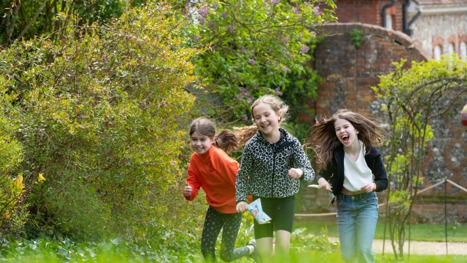 three children running through grounds of Stonor Park