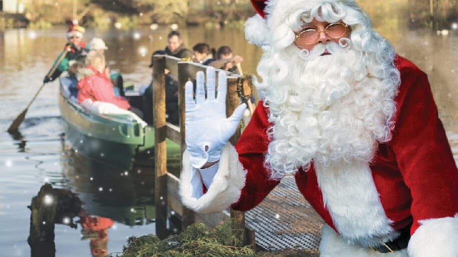 Santa waving to visitors by his boat at Arundel Wetland Centre in Sussex.