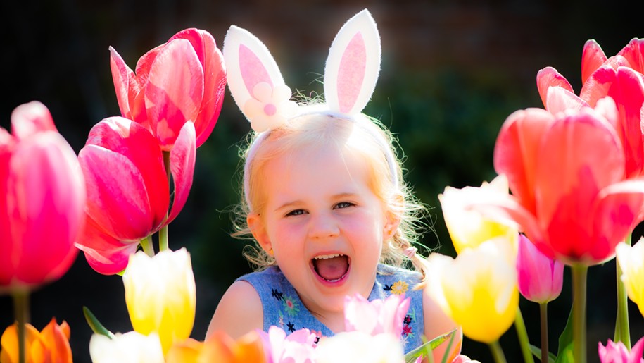 Child laughing in the spring flowers at Holkham