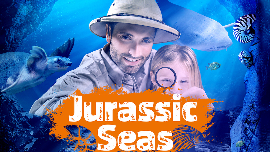 Man and girl with magnifying glass at Jurassic Seas event at Sea Life Manchester